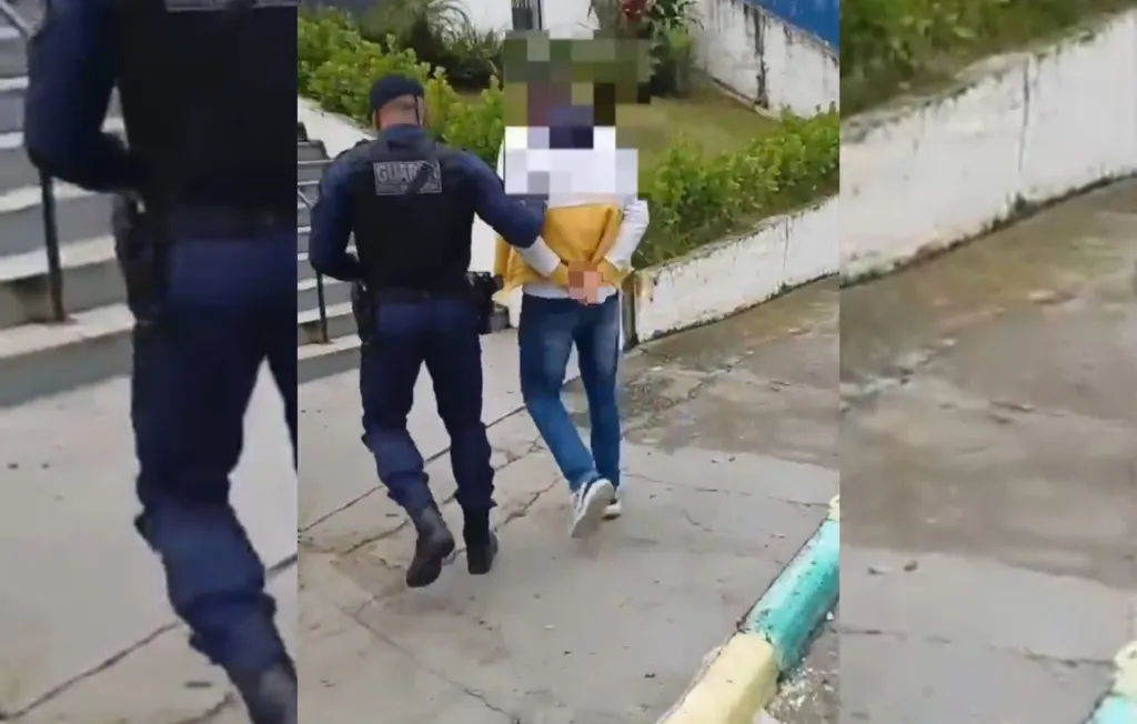Um GCM escoltando um homem suspeito de fraude a delegacia de polícia de Caieiras